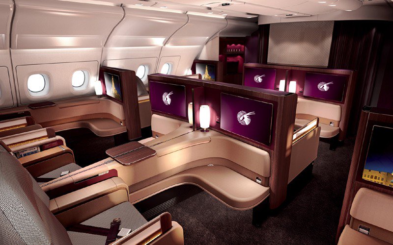 Premium business class suite with lie-flat bed and privacy doors